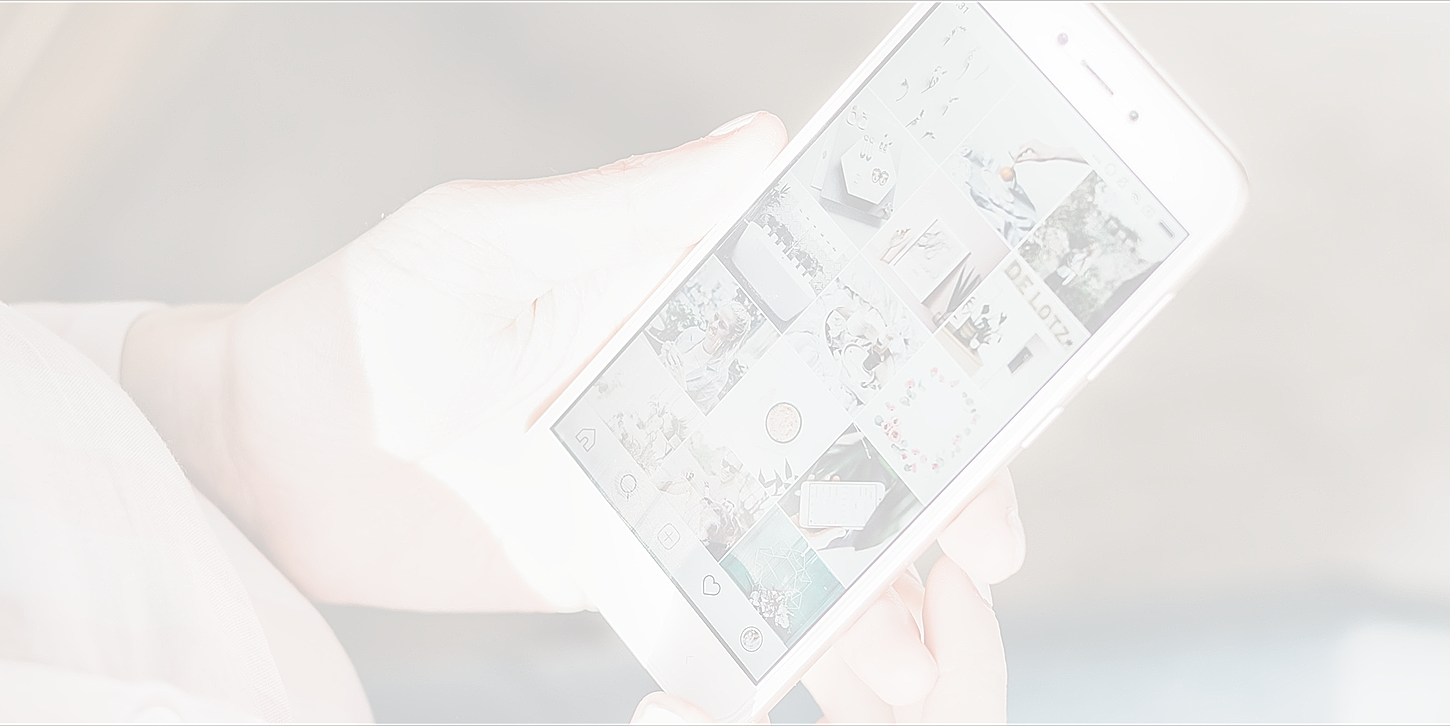 Person holding smartphone displaying social media feed.